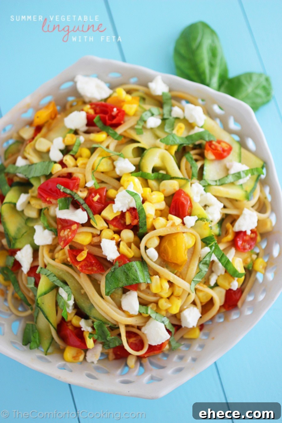 Sun-Kissed Linguine Tossed with Summer Vegetables and Feta 4 A generous serving of Summer Vegetable Linguine with Feta on a white plate, garnished with fresh basil. Features whole wheat linguine and colorful vegetables.