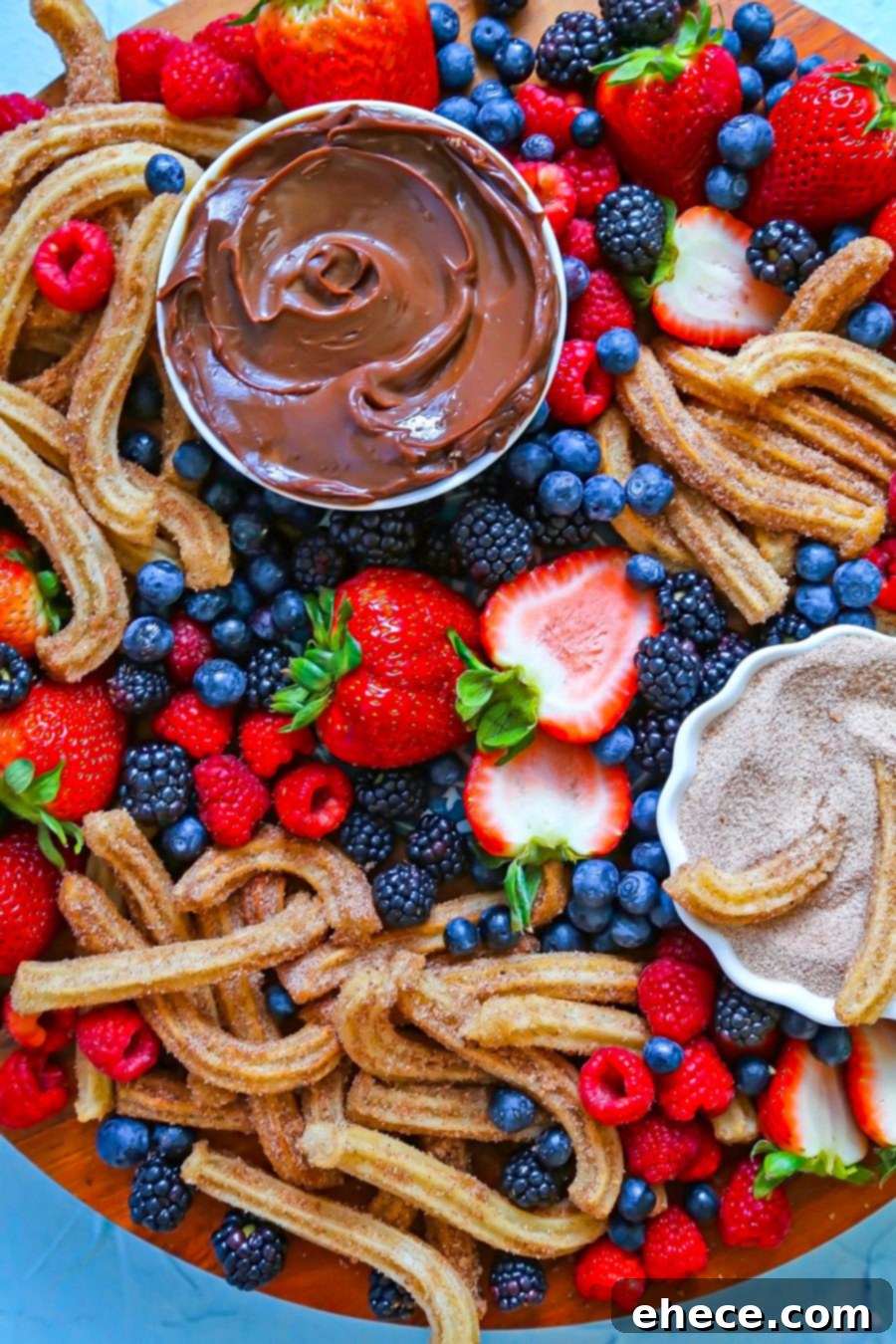 An overhead shot showcasing the colorful and artfully arranged Churro and Berry Dessert Board.