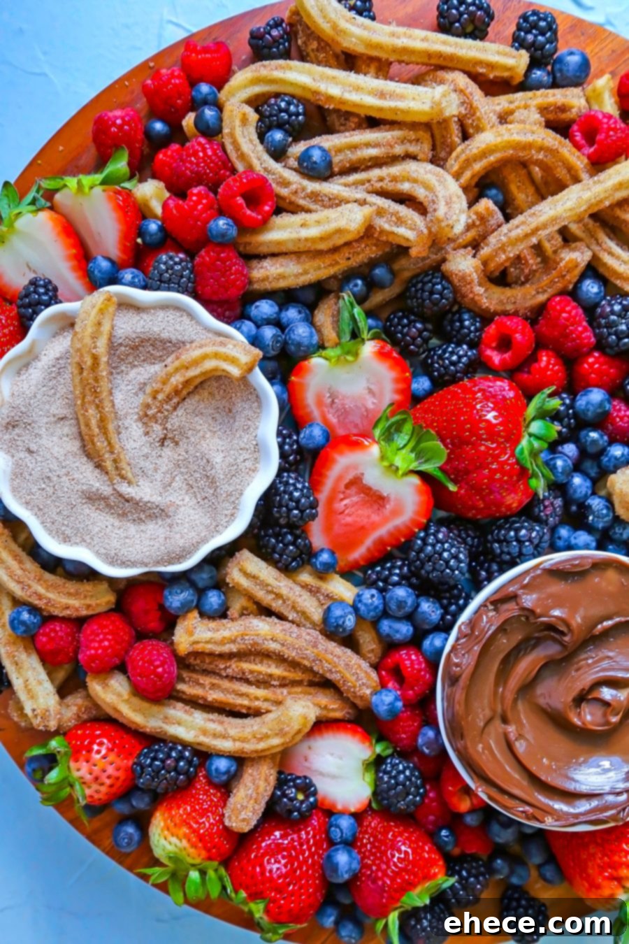 A close-up of a hand dipping a churro into the rich Dulce de Leche Chocolate Sauce.