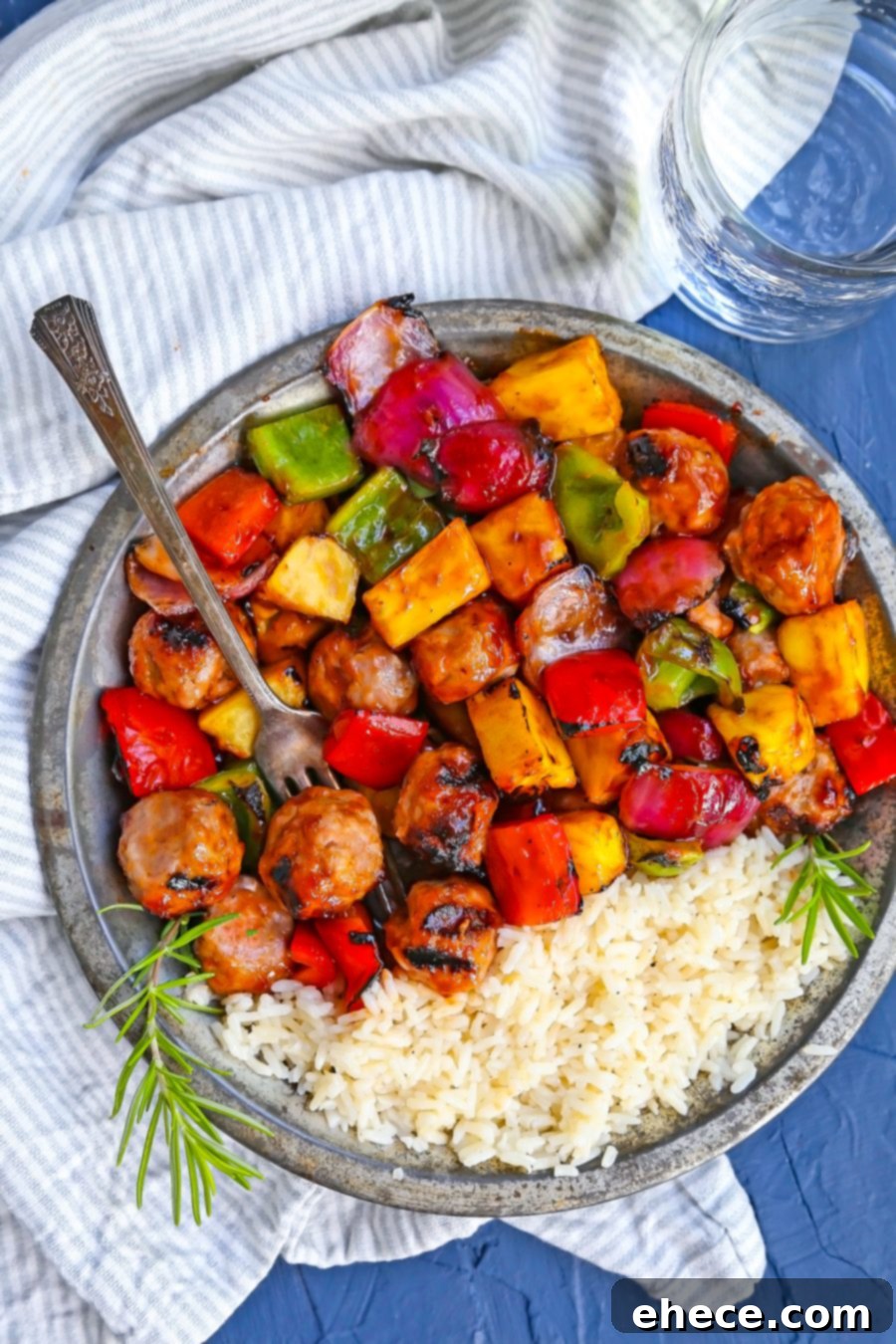 A large platter of grilled BBQ Sausage, Veggie, and Pineapple Skewers ready to serve.