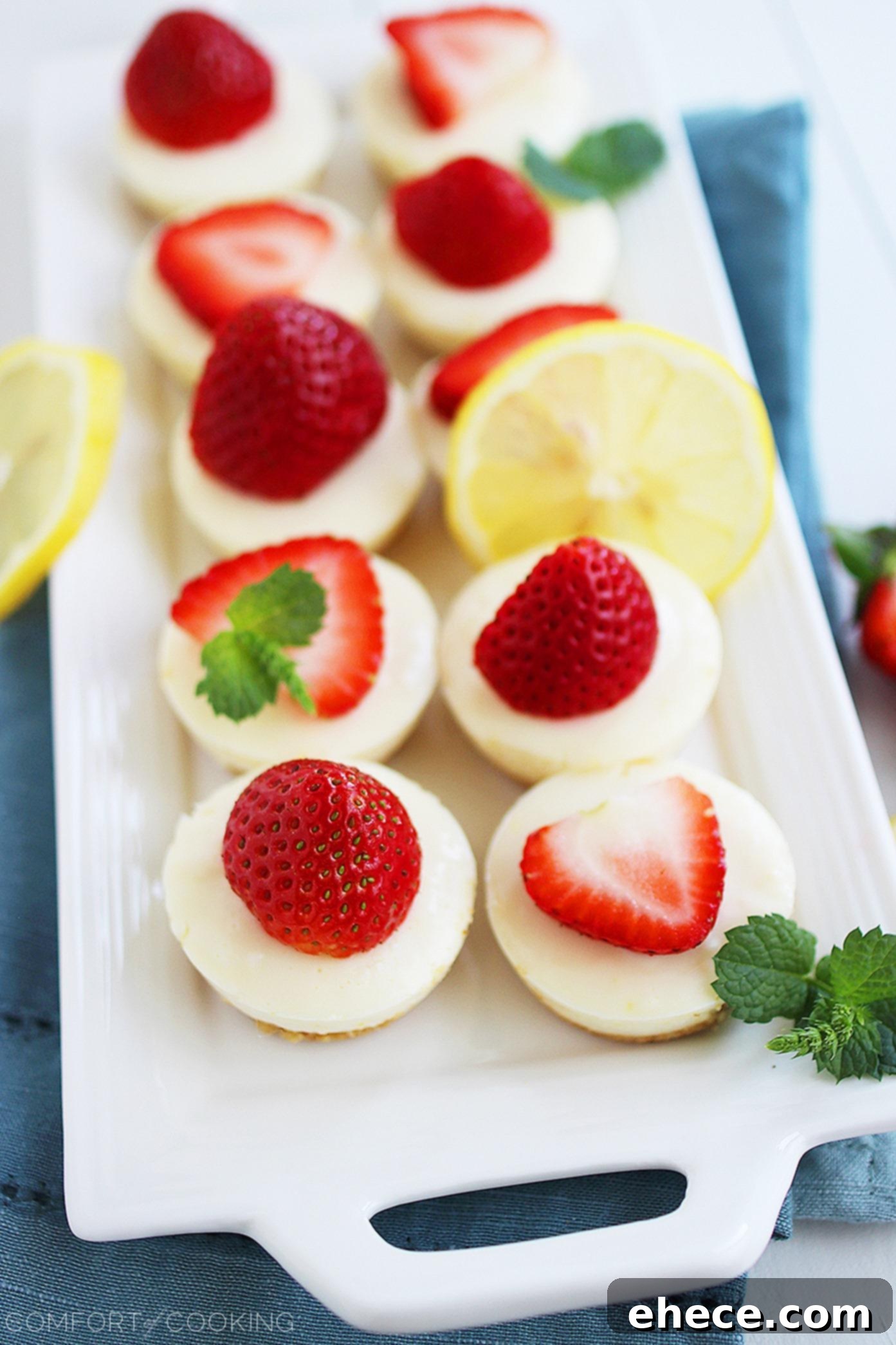Delicious No-Bake Strawberry Lemonade Bites on a white platter, garnished with fresh strawberries