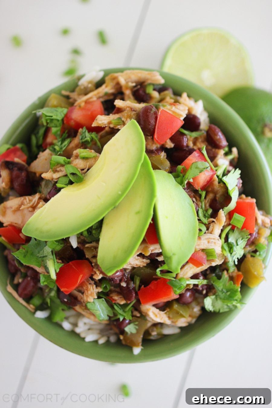 Slow Cooked Zesty Salsa Verde Chicken 3 A close-up shot of Slow Cooker Salsa Verde Chicken in a crockpot, highlighting its rich texture and vibrant colors.