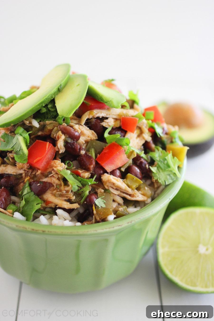 Slow Cooked Zesty Salsa Verde Chicken 4 Slow Cooker Salsa Verde Chicken served in a bowl with fresh toppings like avocado and cilantro.