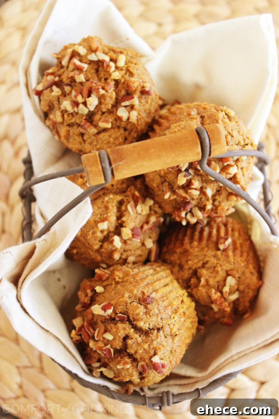 Tender Whole Grain Apple Pumpkin Delights 4 A close-up of a Super Soft 100% Whole Wheat Apple-Pumpkin Muffin, showcasing its moist interior and generous distribution of spices.