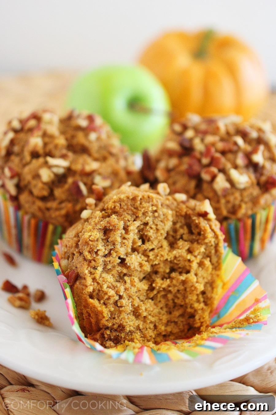 Tender Whole Grain Apple Pumpkin Delights 5 A platter of freshly baked whole wheat apple-pumpkin muffins, ready to be enjoyed with a cup of coffee or tea.