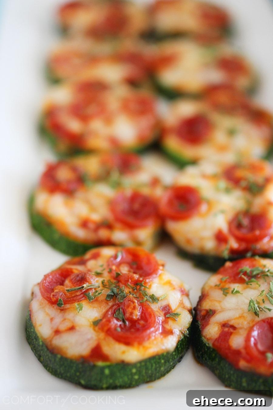 Freshly baked Zucchini Pizza Bites arranged on a platter