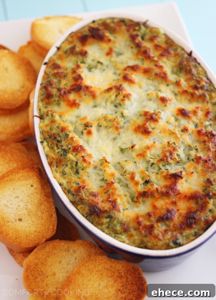 Hot Cheesy Spinach-Artichoke Dip – Super easy, cheesy dip that pairs perfectly with toasty baguettes, crackers and pretzels! A perfect party appetizer or cozy night in treat.