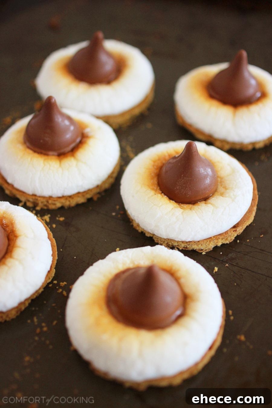A plate of freshly made 3-Ingredient S'mores Bites with a hand reaching for one, emphasizing their readiness and deliciousness as a quick snack.