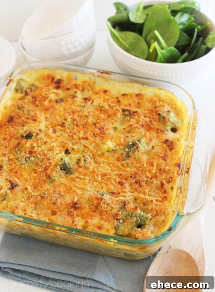 Creamy baked broccoli mac and cheese in a casserole dish, fresh from the oven, with a golden crust.