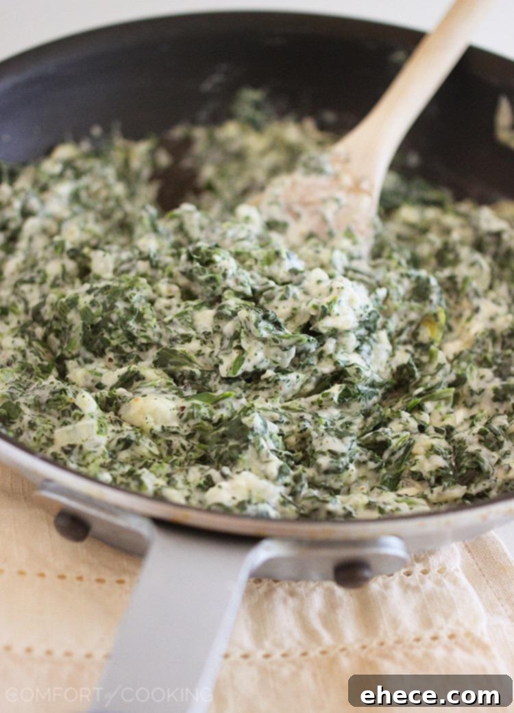 Creamy Lighter Creamed Spinach in a bowl, ready to be served, showcasing its indulgent texture and vibrant green.