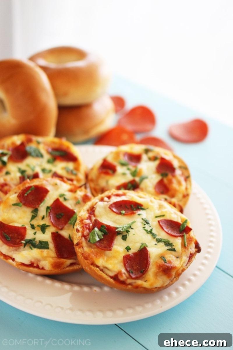 Easy Mini Bagel Pizzas – Crispy, cheesy pizzas on top of mini bagels, piled with your favorite toppings and baked to golden brown perfection. So fun for parties! | thecomfortofcooking.com