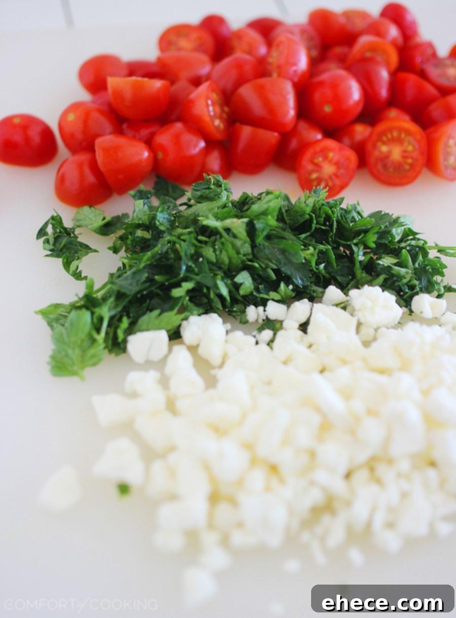 Greek Pita Pizzas – Super easy & full of Mediterranean flavor. Creamy feta, fresh tomatoes and a quick homemade tomato sauce make them mouthwatering!