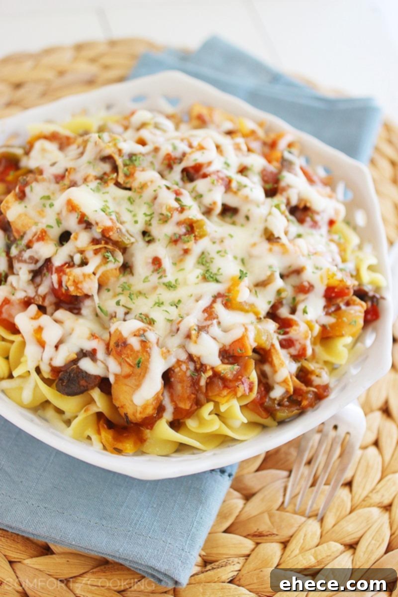 Cheesy Crockpot Chicken Cacciatore – Gooey, hearty and packed with veggies! Serve it over pasta, egg noodles or rice, and add a salad! | thecomfortofcooking.com