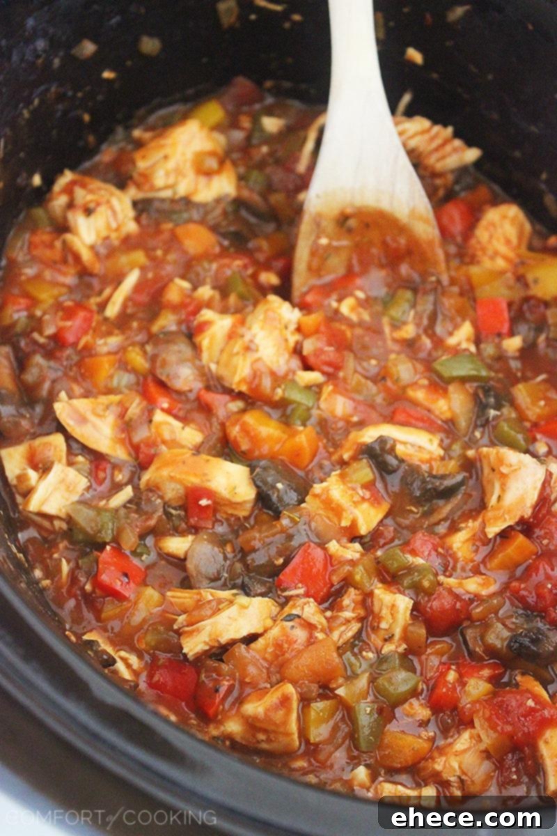 Cheesy Crockpot Chicken Cacciatore – Gooey, hearty and packed with veggies! Serve it over pasta, egg noodles or rice, and add a salad! | thecomfortofcooking.com