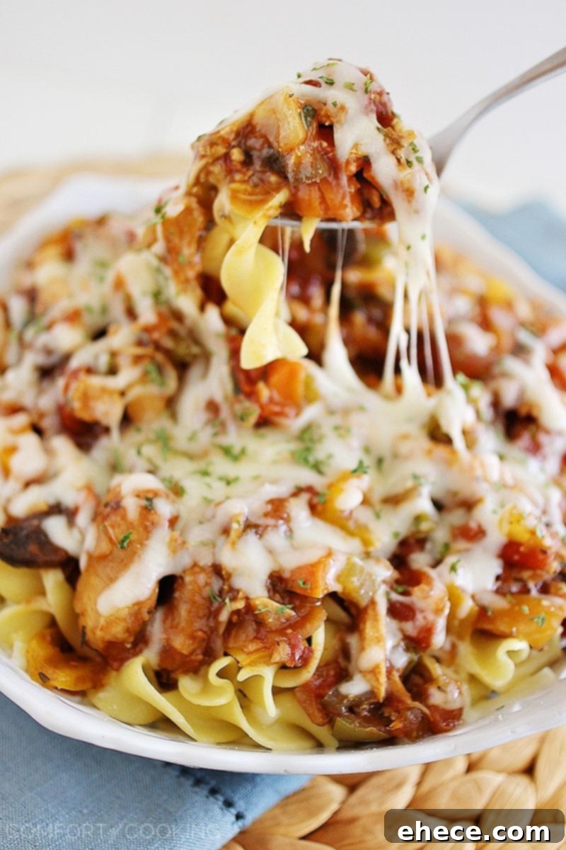 Cheesy Crockpot Chicken Cacciatore – Gooey, hearty and packed with veggies! Serve it over pasta, egg noodles or rice, and add a salad! | thecomfortofcooking.com