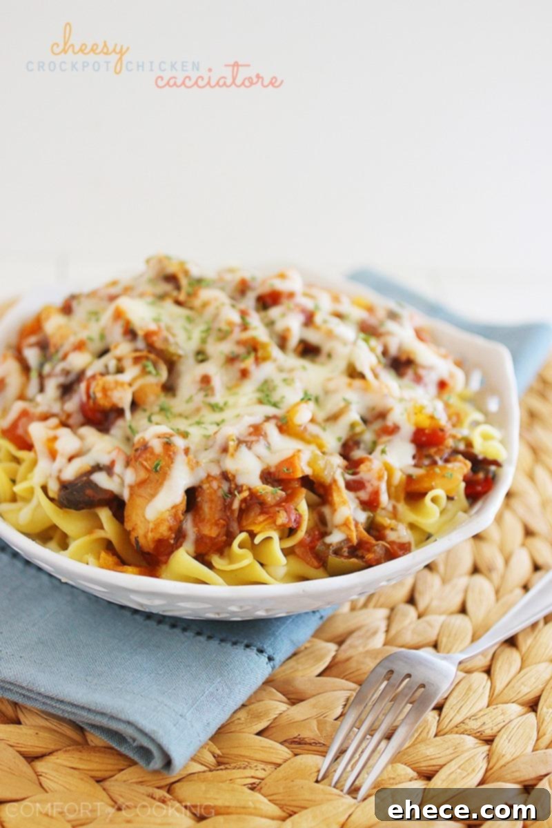 Cheesy Crockpot Chicken Cacciatore – Gooey, hearty and packed with veggies! Serve it over pasta, egg noodles or rice, and add a salad! | thecomfortofcooking.com