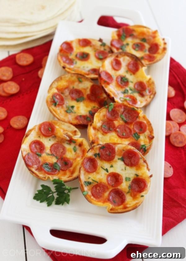 Easy Mini Tortilla Pizzas – Crisp and gooey pizzas, ready in 10 minutes with just 4 ingredients. Bake 'til bubbly and golden in your muffin tin!