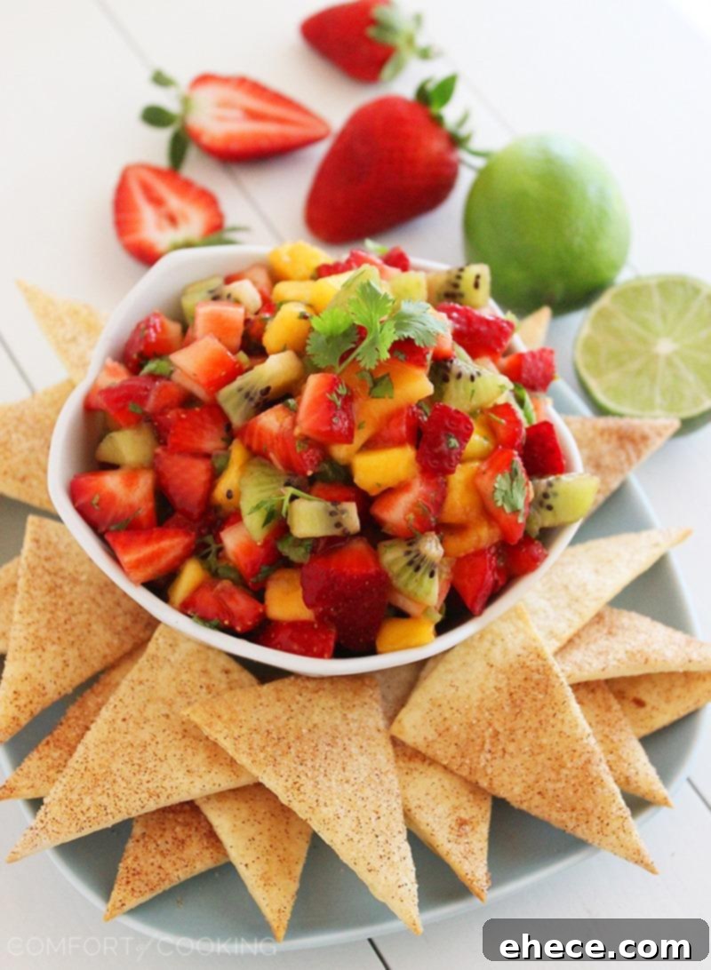 Freshly made Strawberry Mango Salsa with crispy Cinnamon-Sugar Tortilla Chips, garnished with mint.