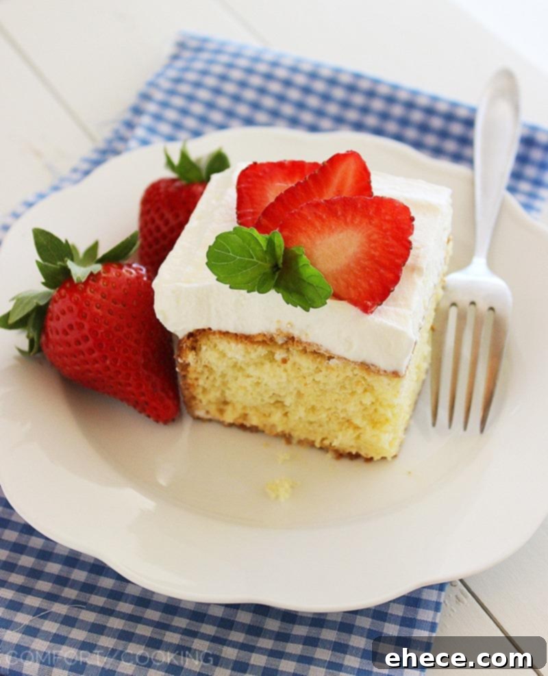 Strawberry Dream Tres Leches 7 Full view of the delectable Tres Leches Cake, generously topped with whipped cream and fresh sliced strawberries.