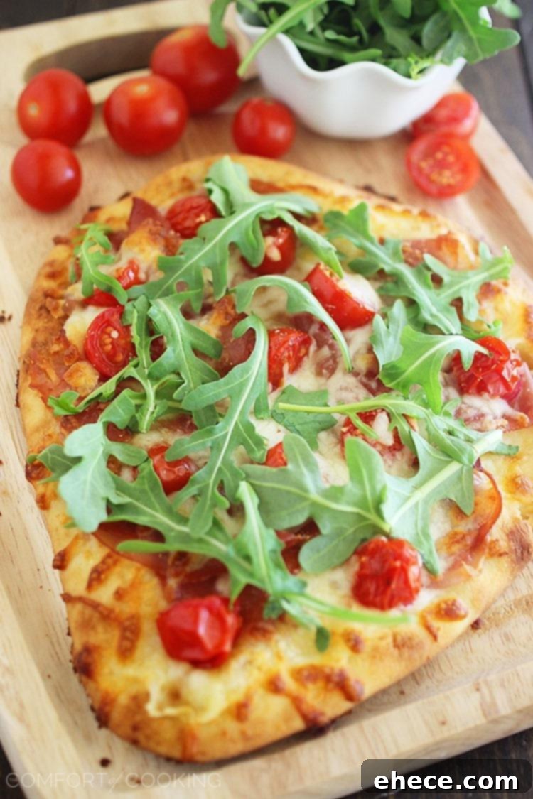 Delicious Prosciutto Arugula and Tomato Naan Pizza