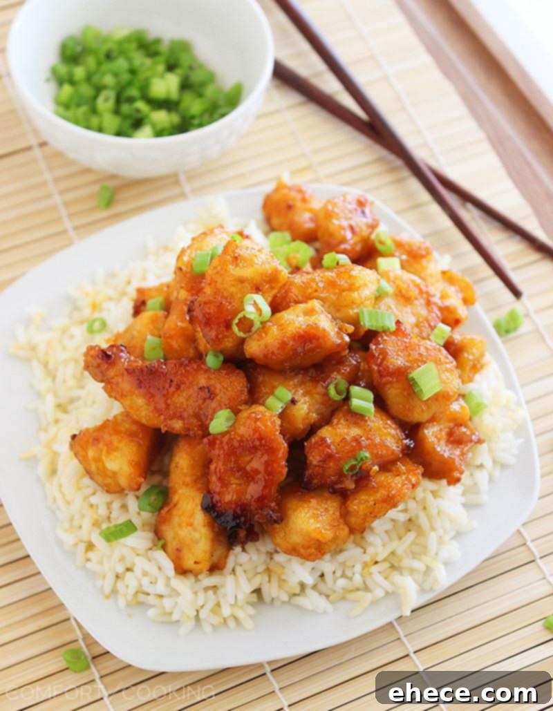Sweet 'n Spicy Firecracker Chicken – Crispy, sticky and spicy chicken served over rice (or tossed with mixed Asian veggies) makes for a colorful and delish weeknight meal. | thecomfortofcooking.com
