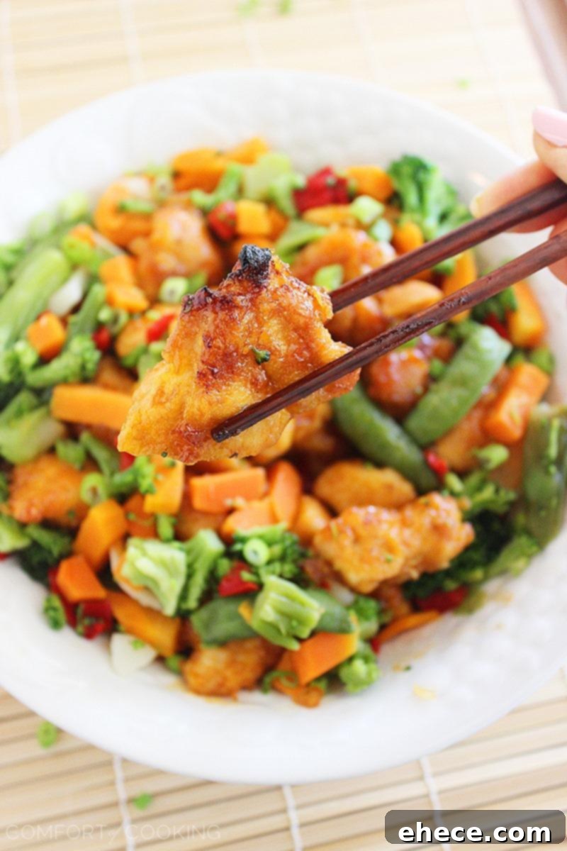 Sweet 'n Spicy Firecracker Chicken – Crispy, sticky and spicy chicken served over rice (or tossed with mixed Asian veggies) makes for a colorful and delish weeknight meal. | thecomfortofcooking.com