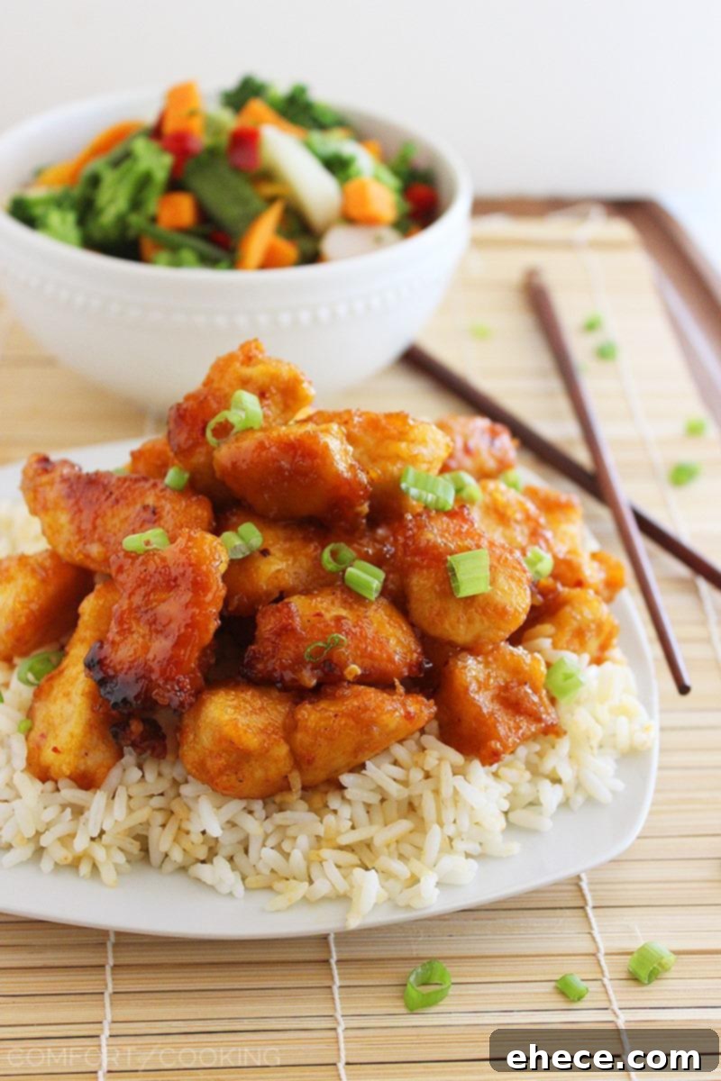 Sweet 'n Spicy Firecracker Chicken – Crispy, sticky and spicy chicken served over rice (or tossed with mixed Asian veggies) makes for a colorful and delish weeknight meal. | thecomfortofcooking.com