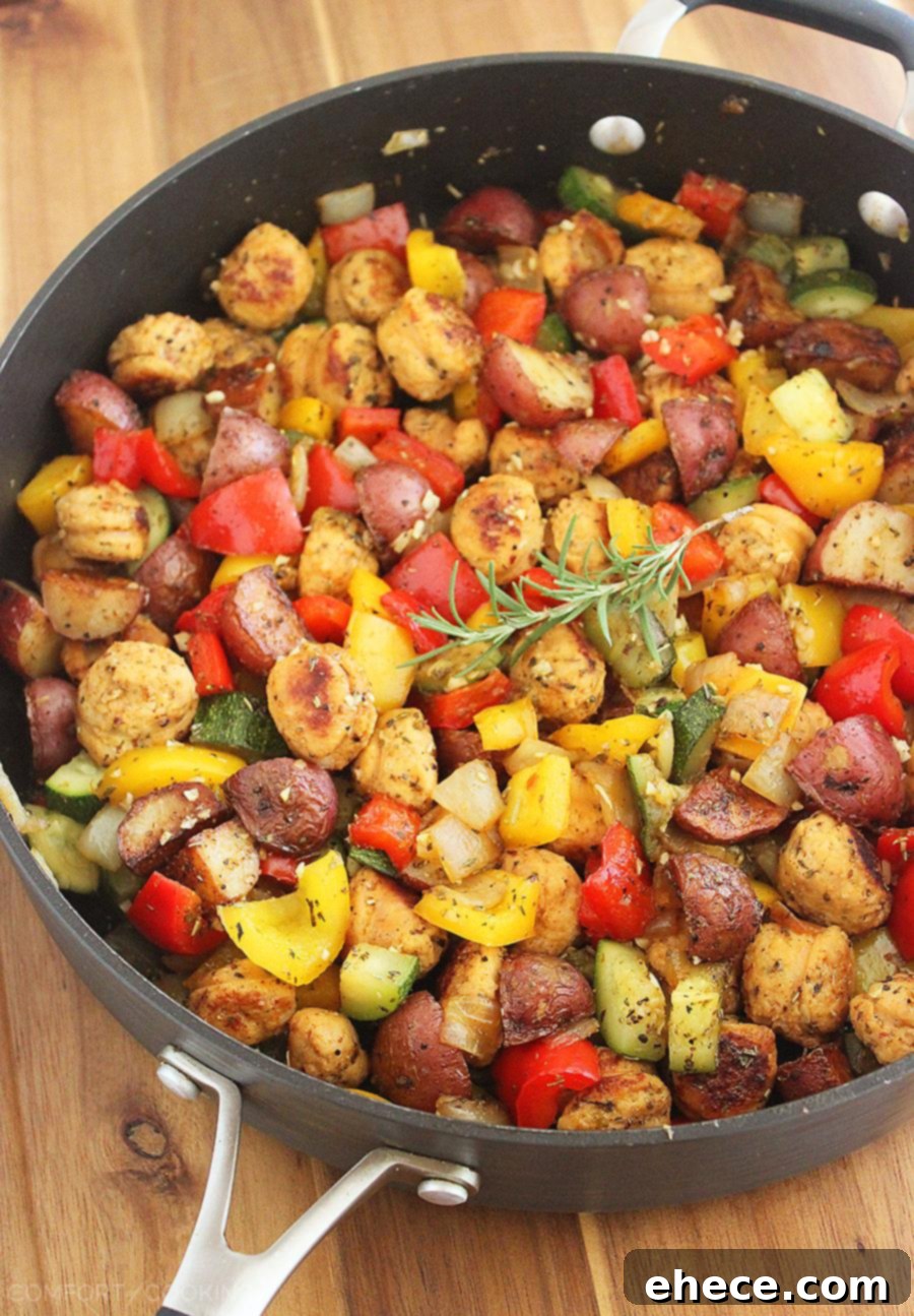 Overhead shot of the cooked Summer Vegetable, Chicken Sausage, and Potato Skillet in a rustic pan, ready for serving, showcasing its appealing presentation.