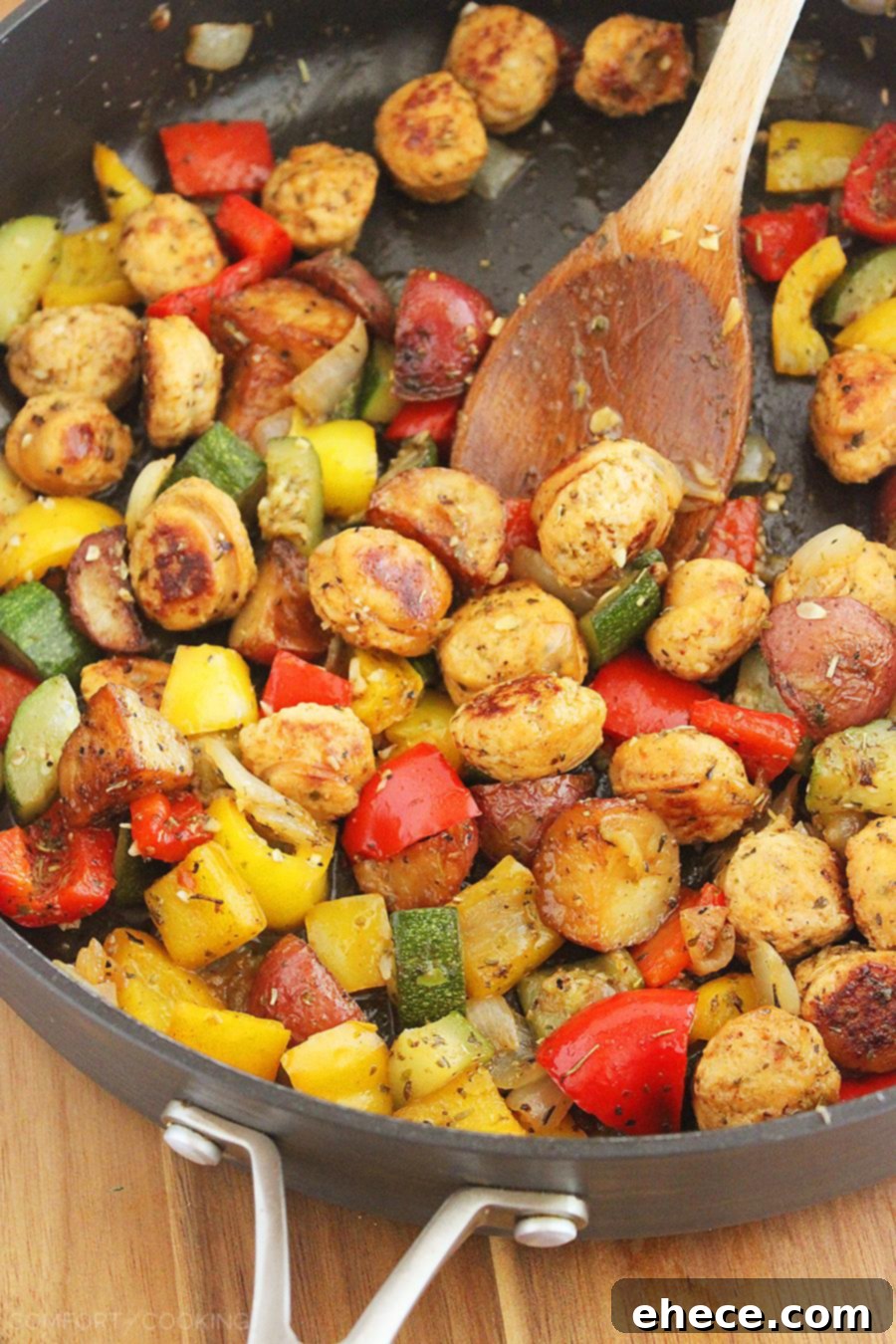 The cooked Summer Vegetable, Chicken Sausage, and Potato Skillet served on a plate, garnished with fresh herbs, showcasing a perfect portion.