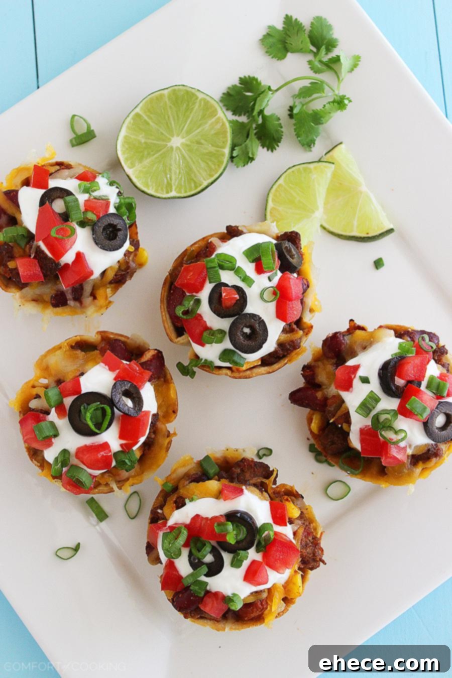 Mini Mexican Chili Tortilla Cups – Hearty, cheesy chili scooped into crisp tortilla shells makes these a huge hit for parties and weeknights! | thecomfortofcooking.com