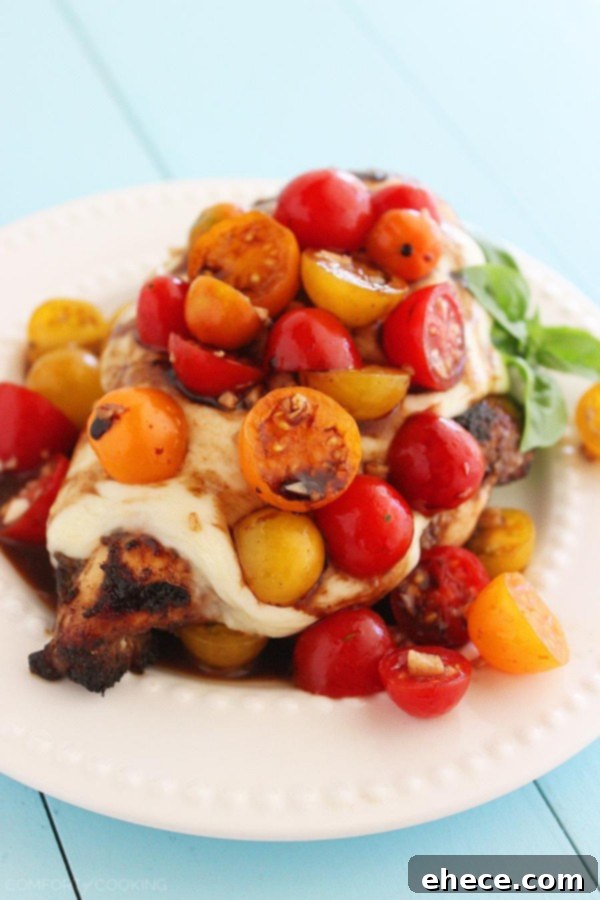 Balsamic Glazed Caprese Chicken 3 Caprese Grilled Chicken - Close-up of grilled chicken topped with melted mozzarella and a vibrant tomato-basil mixture.