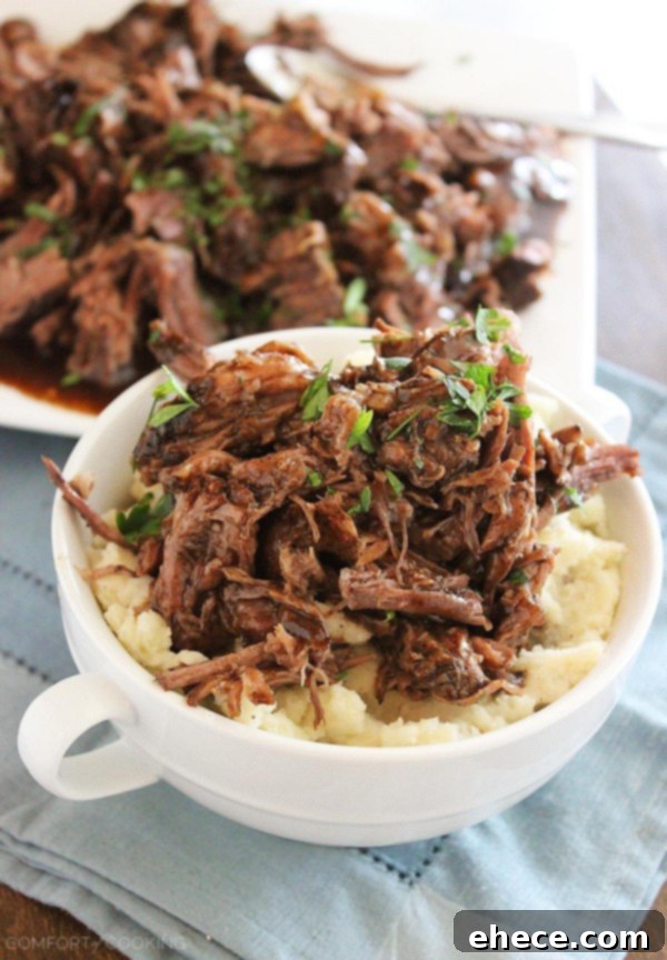 Serving of slow cooker balsamic glazed roast beef with mashed potatoes, garnished, ready to be eaten.