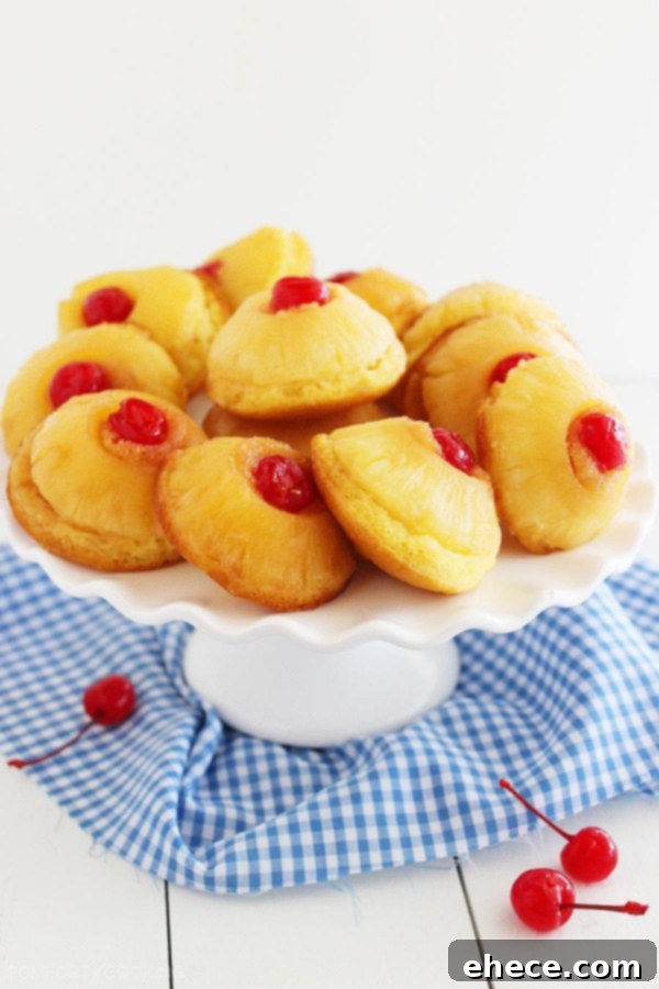 Delicious Mini Pineapple Upside Down Cakes, a lighter version with butter, brown sugar, and a cherry topping. Each cake is under 185 calories. | thecomfortofcooking.com