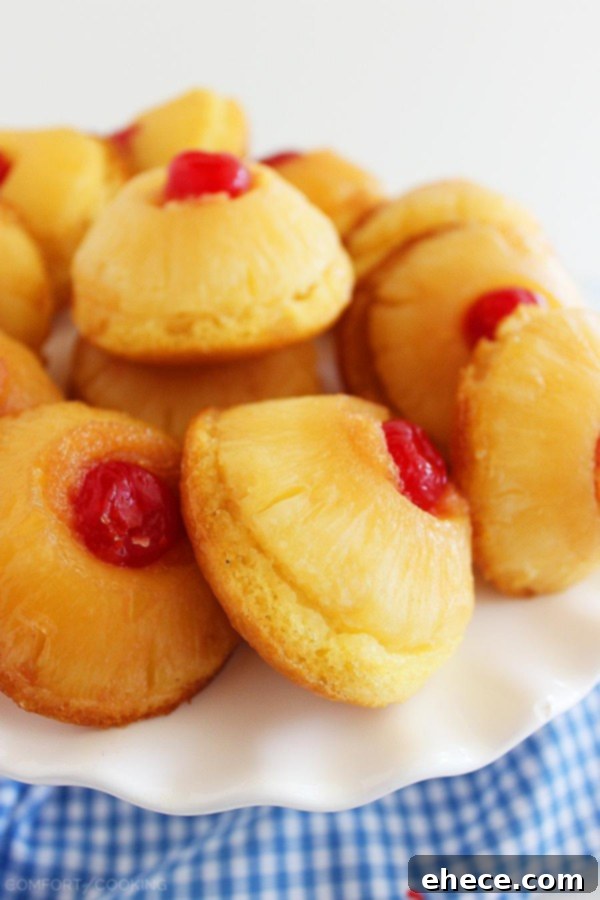 Close-up of a Mini Pineapple Upside Down Cake, showcasing the caramelized pineapple and bright maraschino cherry. A perfect guilt-free summer dessert. | thecomfortofcooking.com