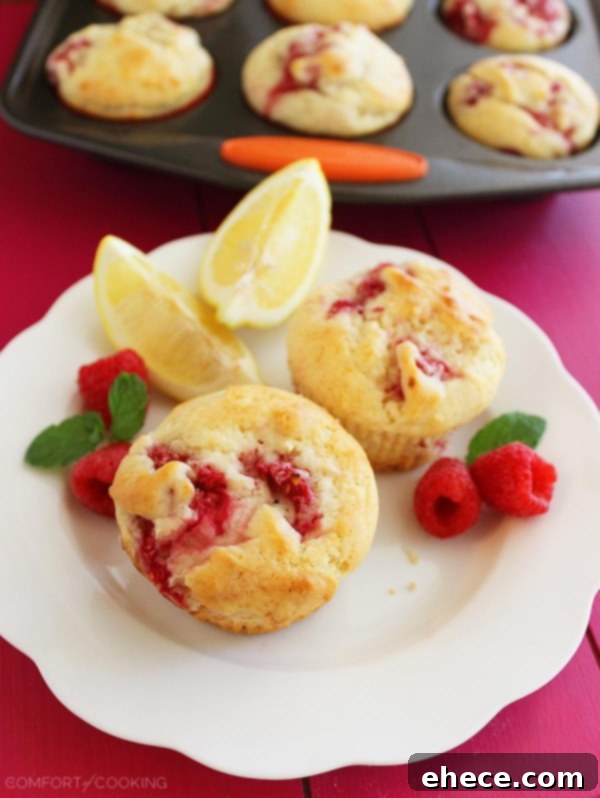 Super Soft Lemon-Raspberry Muffins – Wake up to a batch of these super soft, summery lemon raspberry muffins. They freeze and reheat easily, too! | thecomfortofcooking.com
