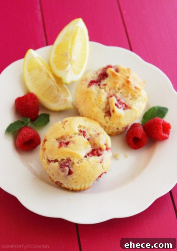 Super Soft Lemon-Raspberry Muffins – Wake up to a batch of these super soft, summery lemon raspberry muffins. They freeze and reheat easily, too! | thecomfortofcooking.com