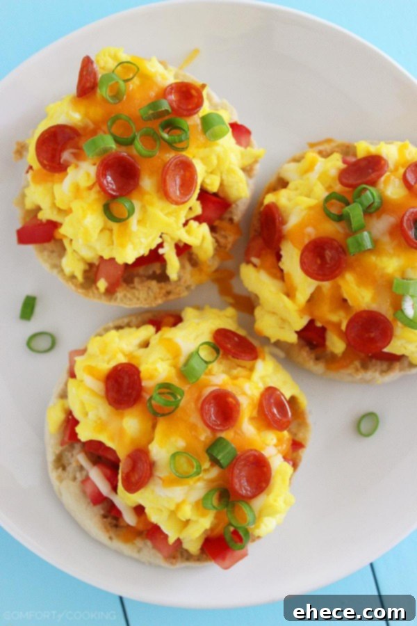 Morning Muffin Pizza Bites 4 English Muffin Breakfast Pizzas – Crisp, buttery English muffins topped with tomatoes, eggs and gooey cheese make the perfect weekend breakfast! | thecomfortofcooking.com