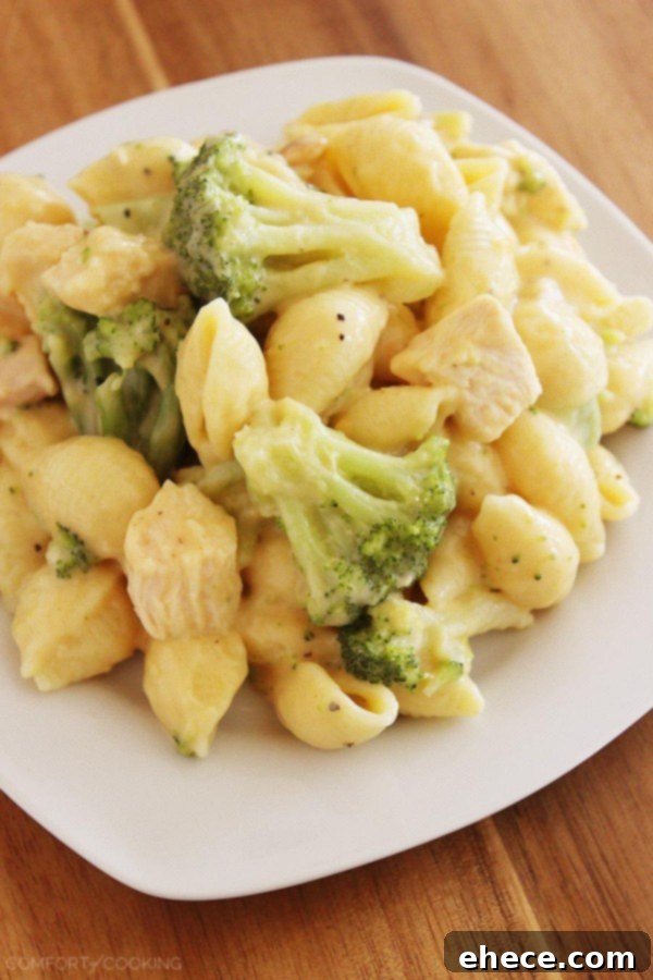 Creamy Chicken and Broccoli Shell Bake 4 A serving of Creamy Broccoli Chicken Shells and Cheese in a bowl, garnished with fresh herbs.