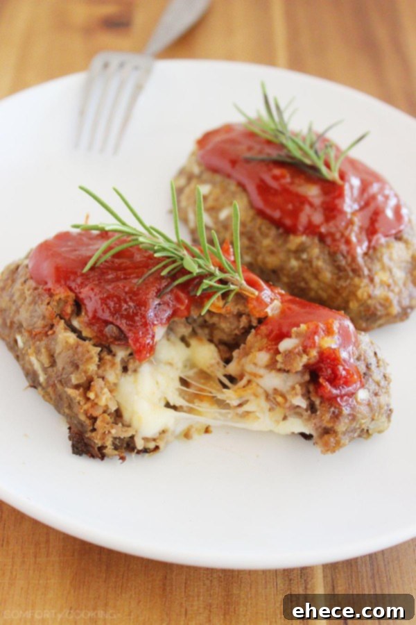 Irresistible Italian Mini Meatloaves with a Mozzarella Surprise 4 A serving of Mozzarella-Stuffed Mini Meatloaves with mashed potatoes and green beans, ready to be enjoyed.
