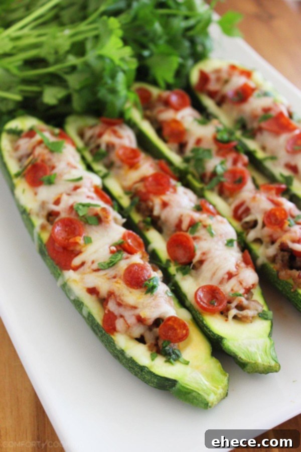 Zucchini Pizza Boats 2 Two freshly baked Pizza Zucchini Boats with melted cheese, pepperoni, and fresh herbs