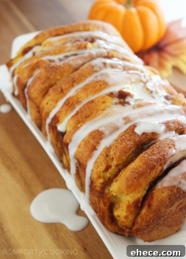 Warm Pumpkin Spice Pull-Apart Delight with Vanilla Glaze 6 A closer look at a section of Pumpkin Spice Pull Apart Bread with oozing pumpkin spice filling
