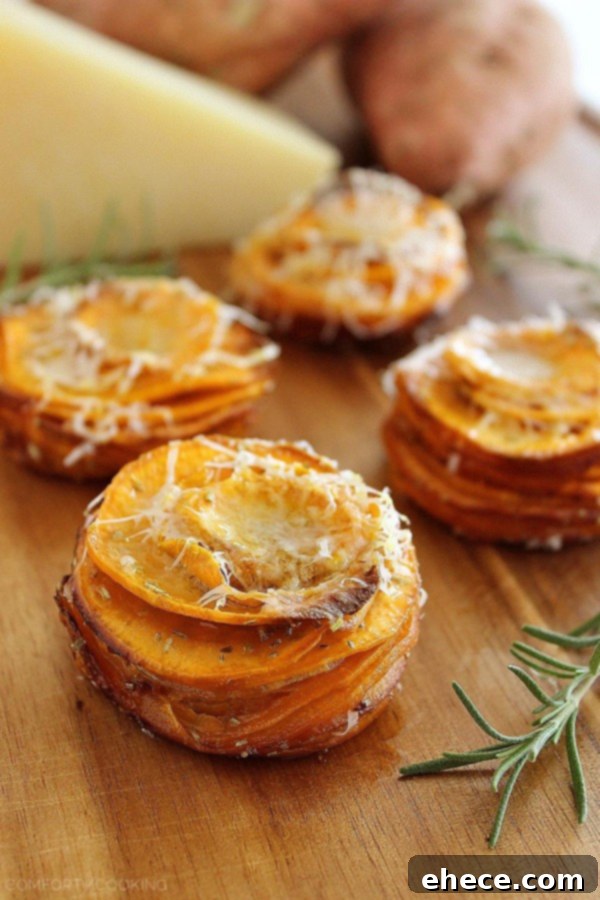 Baked sweet potato stacks garnished with fresh rosemary and Parmesan
