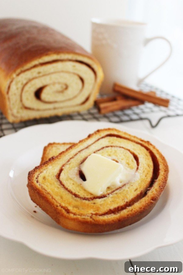Another enticing view of a slice of cinnamon swirl bread, highlighting the texture and perfect golden-brown crust.