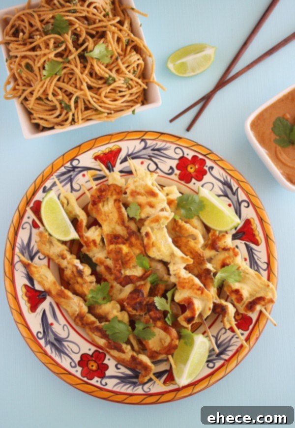 Coconut Ginger Chicken Satay with Sriracha Cream 3 Close-up shot of grilled chicken satay skewers arranged beautifully with a side of creamy Sriracha sauce.