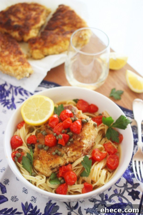 Crispy Chicken Scallopini with Lemony Butter-White Wine Sauce and Blistered Tomatoes, served with pasta.