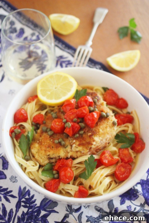 Serving suggestion for crispy chicken scallopini with pasta and fresh herbs.