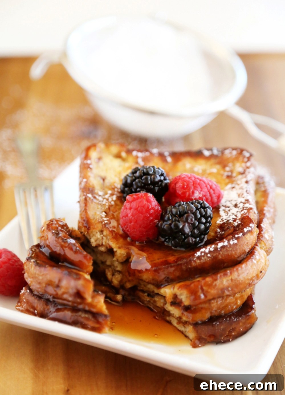Beautifully prepared Cinnamon Swirl French Toast, garnished with a medley of fresh berries. A perfect sweet breakfast treat.