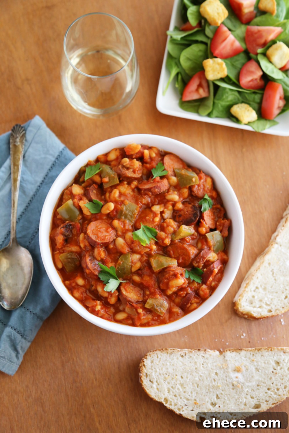 Savory Sausage, Peppers & White Bean Pot 3 Preparation shot of slow cooker ingredients: sliced smoked sausage, chopped green peppers, and onions ready to be combined.