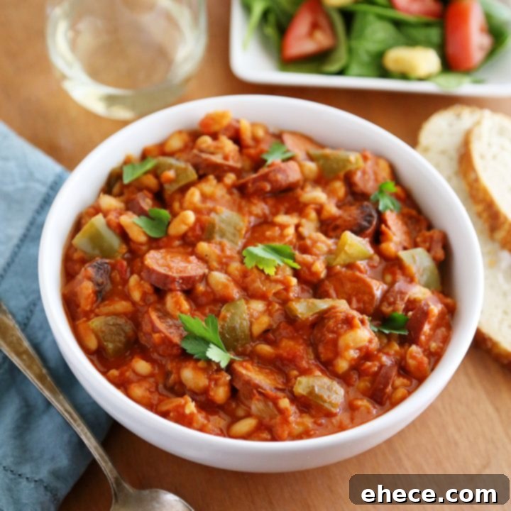 Savory Sausage, Peppers & White Bean Pot 6 Hearty slow cooker sausage and white beans in a rich tomato sauce, served in a bowl.