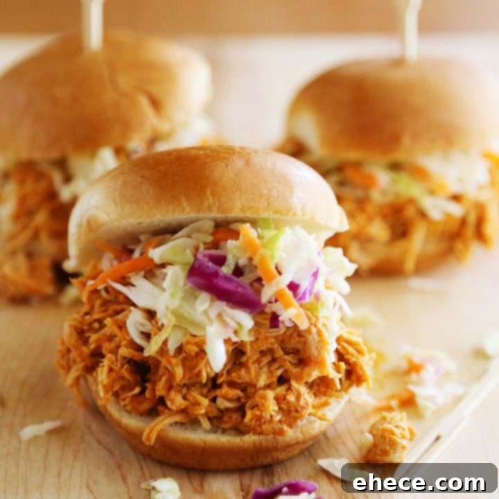 Tangy Slow Cooker Buffalo Chicken Sliders 4 Slow Cooker Buffalo Chicken Sliders, a delicious and easy recipe perfect for parties or weeknight dinners, served on a platter.